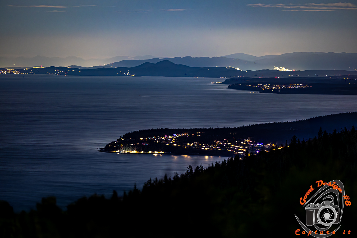 Salish sea with mountain Lanscape lit up at night with city lights