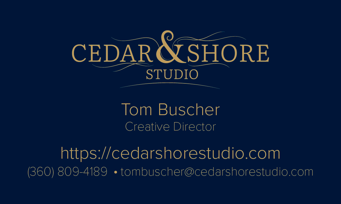 cedar and shore studio business card with gold font and blue background